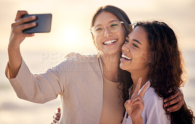 Buy stock photo Shot of two beautiful young women taking a selfie together outside