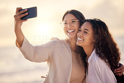Buy stock photo Shot of two beautiful young women taking a selfie together outside