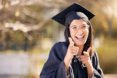Buy stock photo Shot of a young woman pointing on graduation day