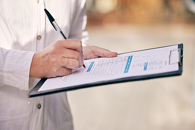 Buy stock photo Cropped shot of a woman writing on a form while standing outside