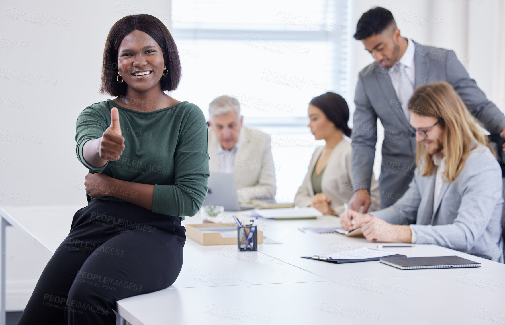 Buy stock photo Shot of a young businesswoman showing thumbs up during a meeting in a modern office