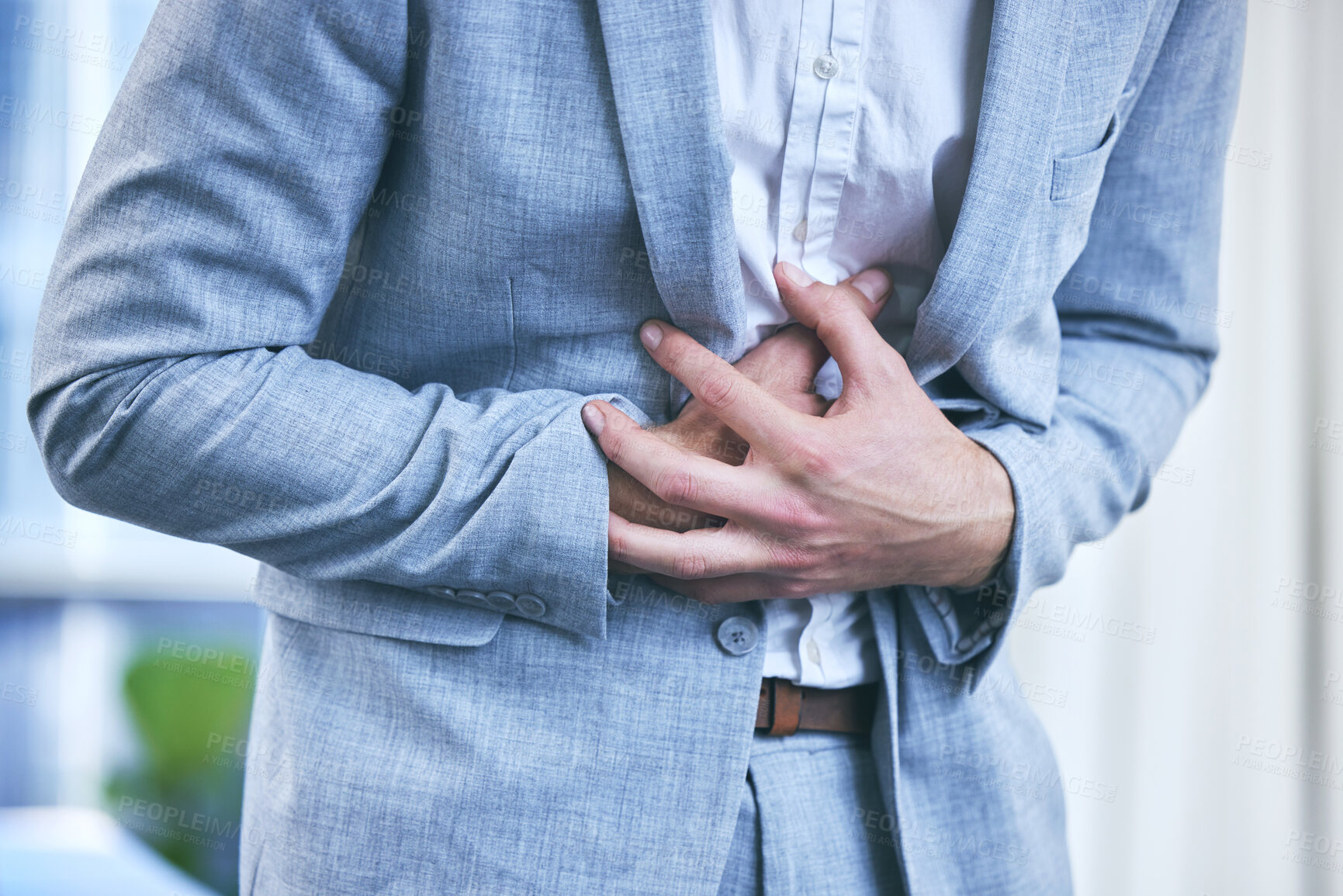 Buy stock photo Cropped shot of a businessman feeling pain in his stomach