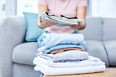 Buy stock photo Folding laundry, person and hands in living room on couch, cotton and fabric clothing. Organizing washing, housekeeper and spring cleaning in lounge for routine, wellness and morning on home sofa