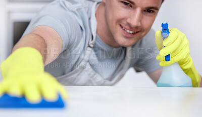 Buy stock photo Spray, kitchen counter and and man with smile, cleaning and housekeeping in home or hotel. Housework, housekeeper or male cleaner service wiping dirt on table with cloth, soap and bottle in apartment