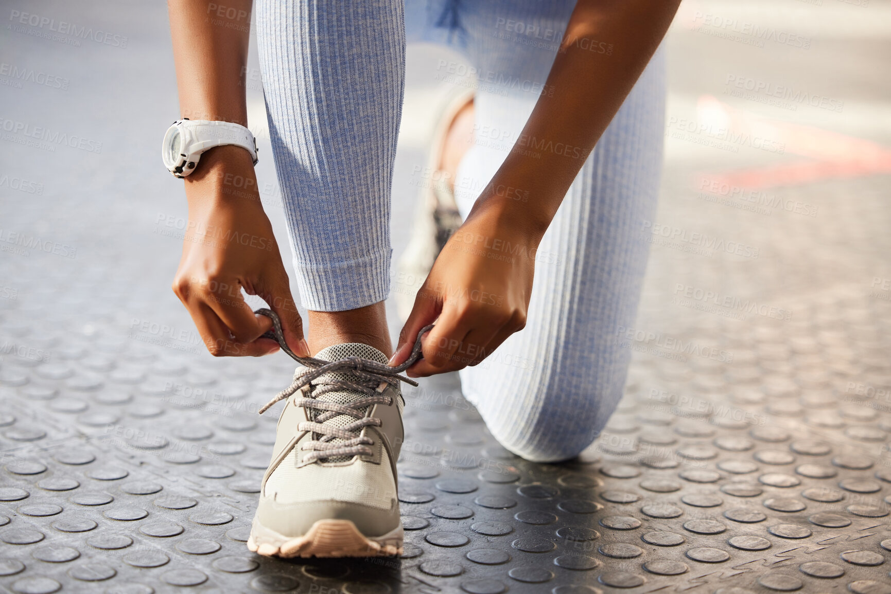 Buy stock photo Shot of an unrecognizable woman tying her shoelaces before a workout in the gym