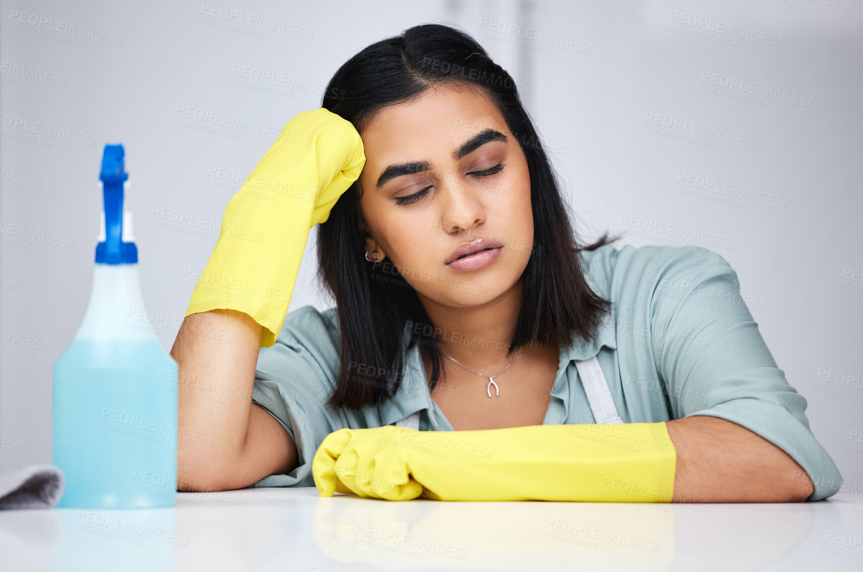 Buy stock photo Woman, sleeping and tired cleaner with spray bottle for table, kitchen counter or dirty furniture in home. Burnout, exhausted maid and lazy Indian janitor on break with product, liquid soap or gloves