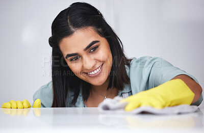 Buy stock photo Indian woman, happy or cleaner with spray bottle for table, kitchen counter or dirty furniture in home. Smile, maid or janitor washing messy surface with product, liquid soap or cloth with gloves 