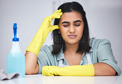 Buy stock photo Woman, headache and tired cleaner with spray bottle for table or dirty furniture in home with burnout. Bored, exhausted maid or lazy Indian janitor on break with stress, liquid soap or migraine pain