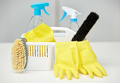 Buy stock photo Table, brush or basket with cleaning supplies, spray bottle or chemical for bacteria, wellness or dirty mess. Grey background, maid service or ready for washing with product, liquid soap or gloves