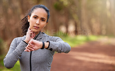 Buy stock photo Woman, resting and check pulse in nature for intensity, fitness and wellness in forest. Brazilian runner, taking break and counting bpm from workout, challenge and goals in woods with copy space