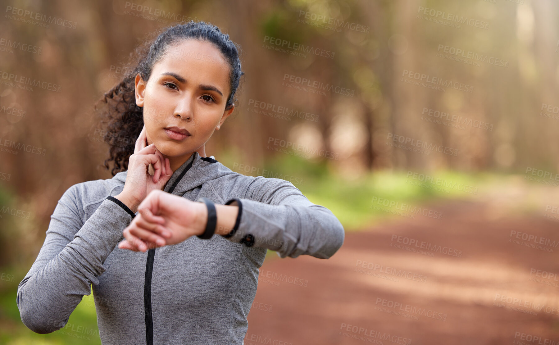 Buy stock photo Woman, resting and check pulse in nature for intensity, fitness and wellness in forest. Brazilian runner, taking break and counting bpm from workout, challenge and goals in woods with copy space