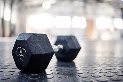 Buy stock photo Dumbbell, exercise equipment and closeup in gym, wellness and health club for training. Fitness, weightlifting and iron weight for sport and muscle workout on the floor with mockup space on ground