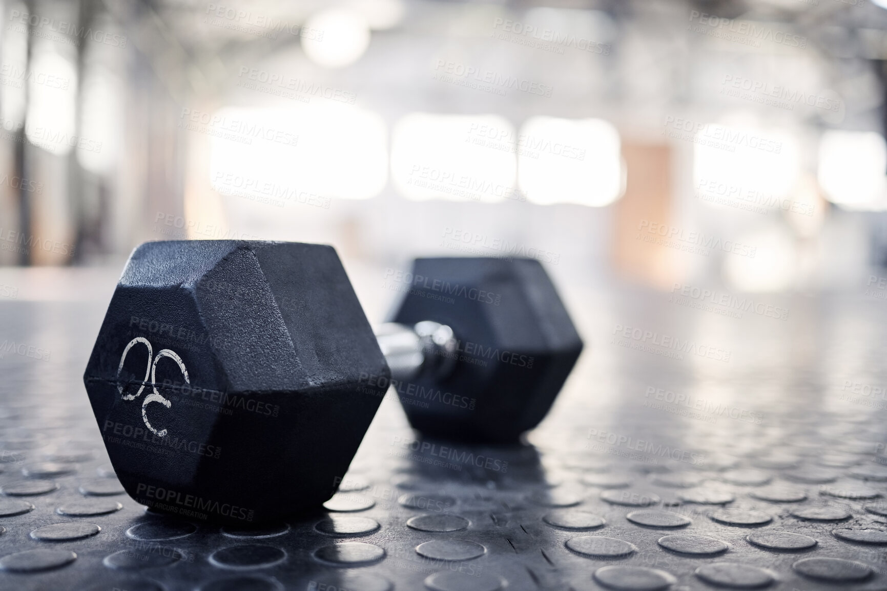 Buy stock photo Dumbbell, exercise equipment and closeup in gym, wellness and health club for training. Fitness, weightlifting and iron weight for sport and muscle workout on the floor with mockup space on ground