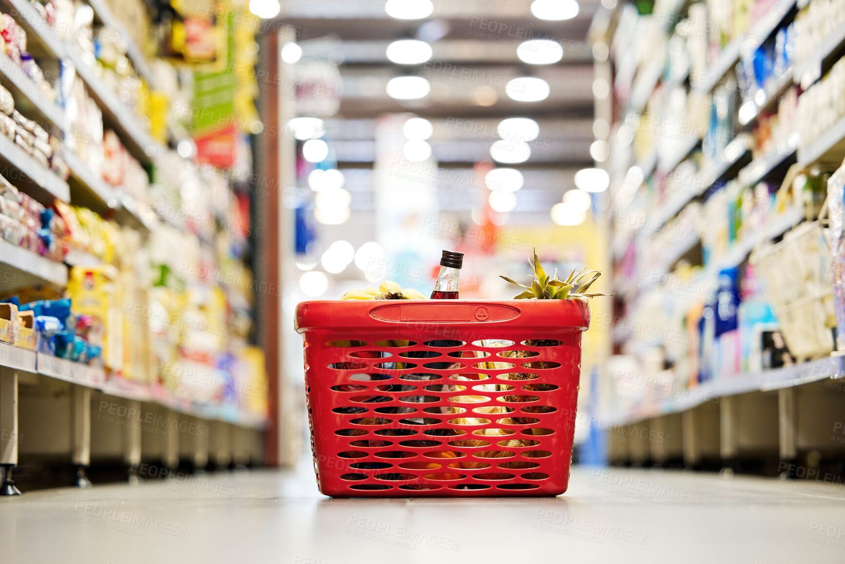 Buy stock photo Shopping basket, floor and grocery store for discount, sale and promotion for food, product and customer experience. Plastic container, supermarket or mall for retail, sales and trading for choice