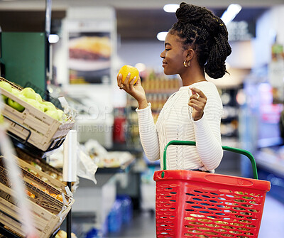Buy stock photo Supermarket, black woman and shopping for grocery, vegetables and customer with orange in store basket. Person, retail shop and groceries, healthy food or buying fruit for vegan diet or nutrition