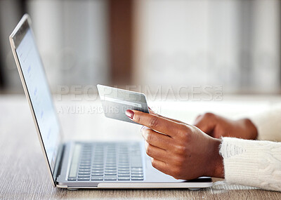 Buy stock photo Shot of an unrecognisable woman using a laptop and credit card while working at home