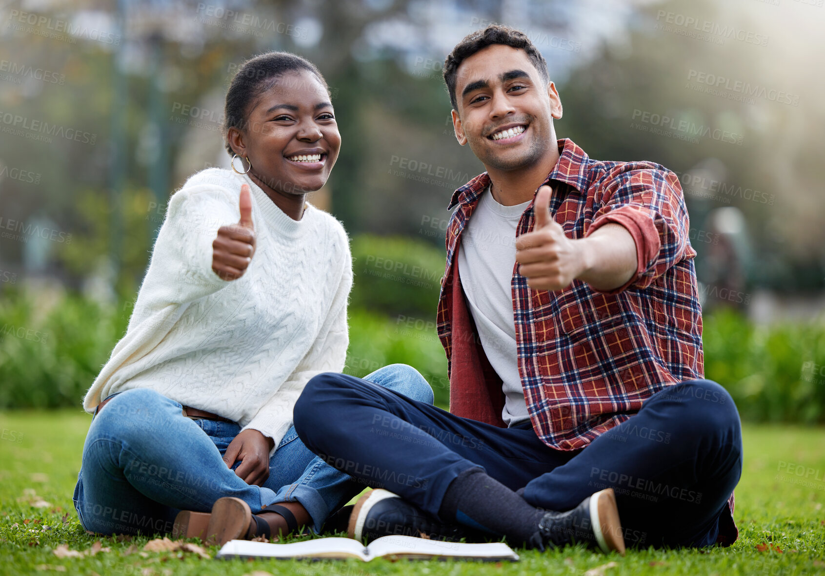 Buy stock photo Portrait, students and friends with thumbs up, outdoor or relax on grass, education or promotion for university. Face, people or man with woman in park, hand gesture or like with symbol, sign or icon