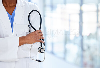 Buy stock photo Shot of an unrecognizable doctor holding a stethoscope at work