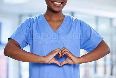 Buy stock photo Shot of an unrecognizable doctor making a heart shape with their hands at work