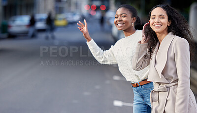 Buy stock photo Shot of two friends hailing a cab after a day of shopping