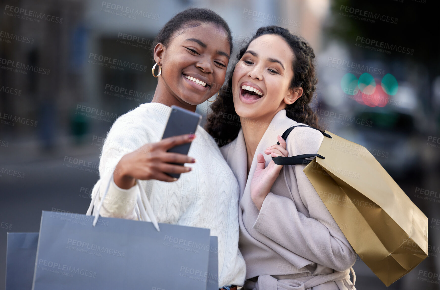 Buy stock photo Shot of two friends taking selfies while shopping together