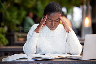 Buy stock photo Shot of a young woman looking stressed while studying in a cafe