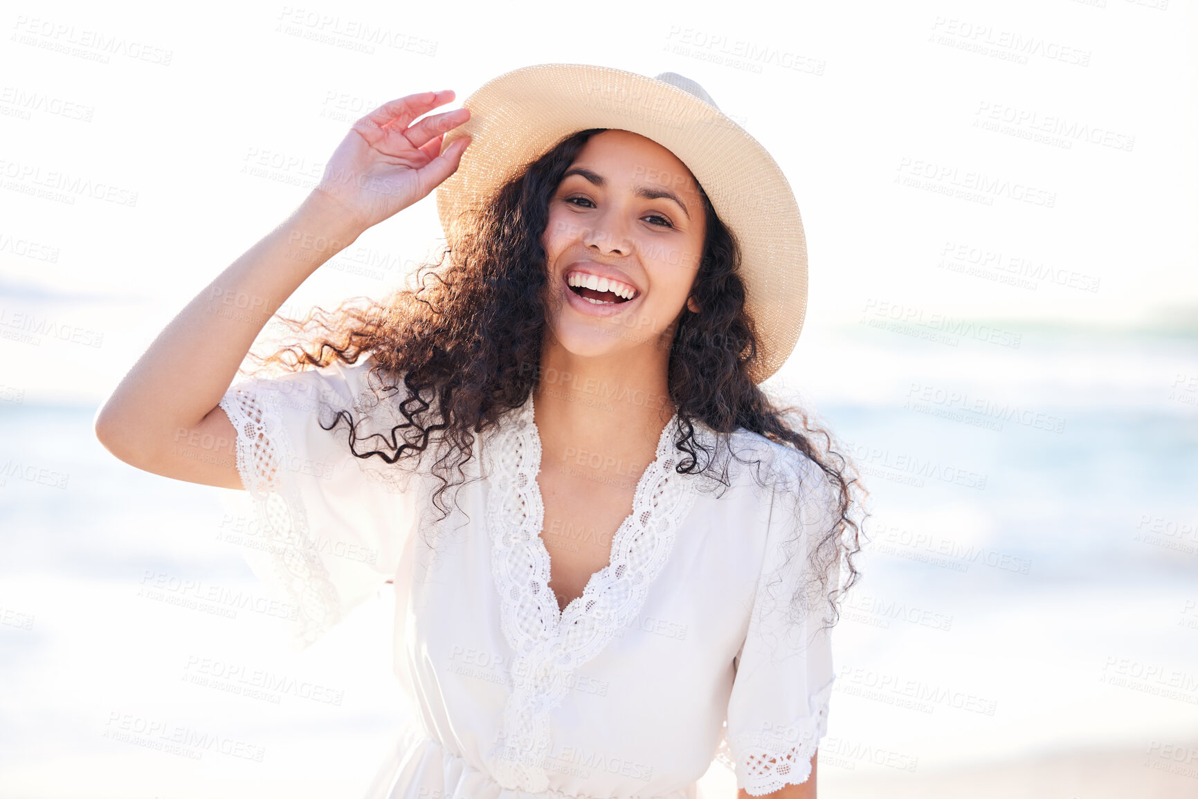 Buy stock photo Shot of a young woman enjoying a day at the beach