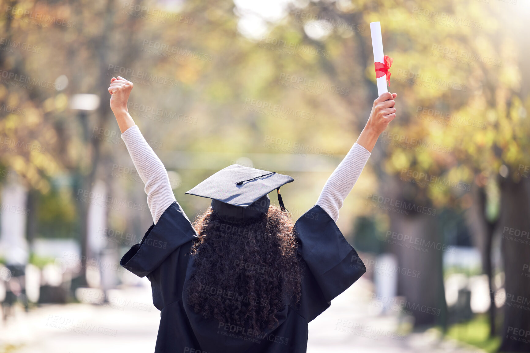 Buy stock photo Graduation, back and woman student celebrating academic success or raising her diploma or victory at university campus with cheers. Motivation, certificate and achievement for happy female person 