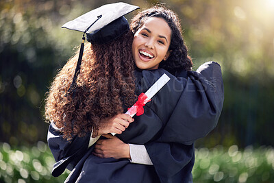 Buy stock photo Shot of two young women hugging on graduation day