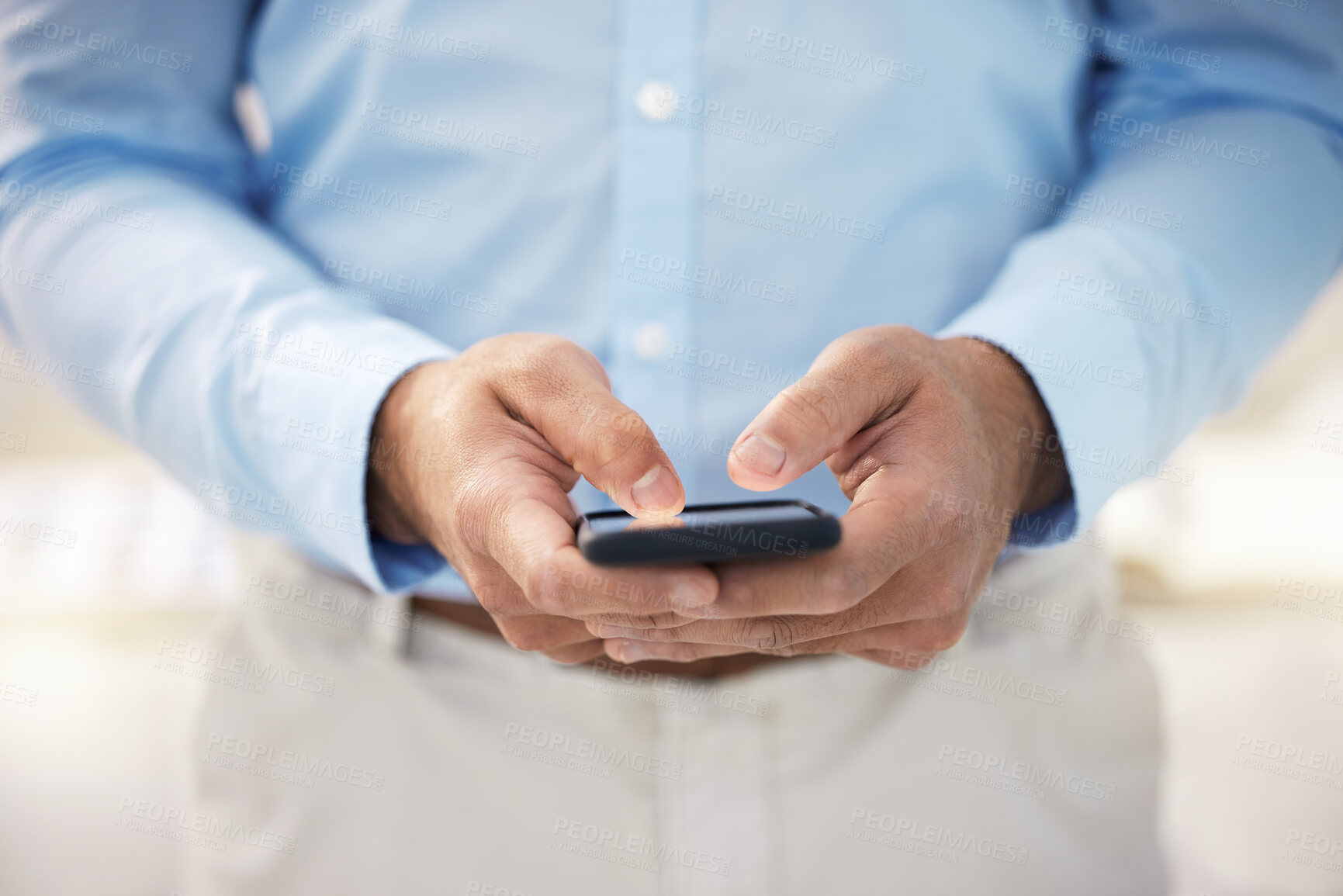 Buy stock photo Shot of a businessman using his smartphone to send a text message