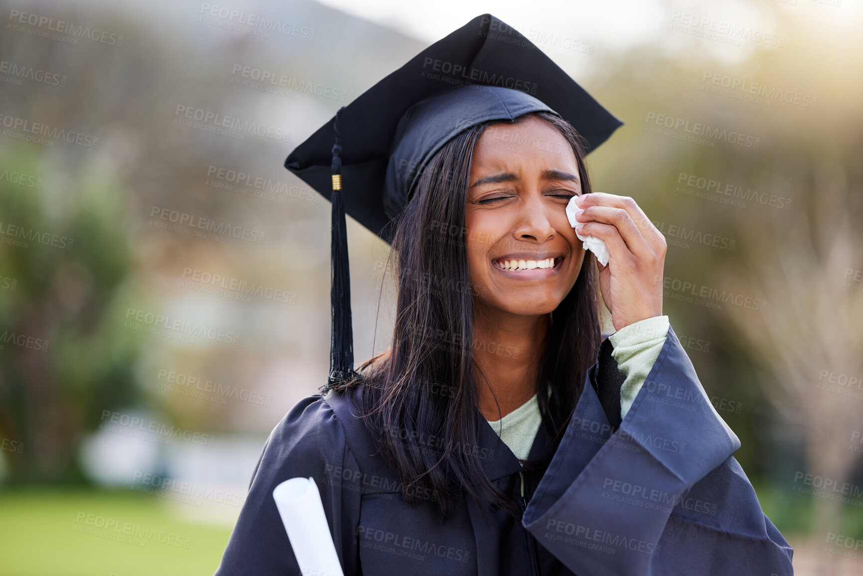Buy stock photo Cropped shot of an attractive young female student crying while while celebrating her graduation day