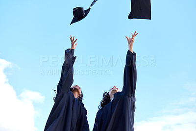 Buy stock photo Low angle shot of two attractive young female students celebrating on graduation day