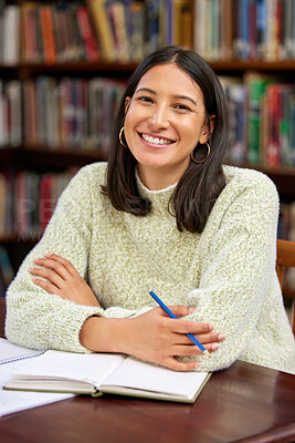 Buy stock photo Shot of a young woman studying in a college library