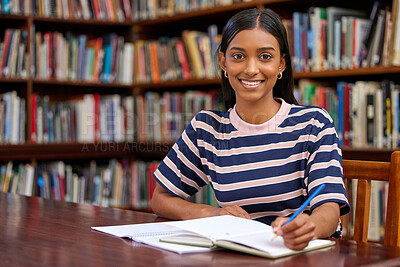 Buy stock photo College, portrait and woman student in library with notebook for education, learning or studying for exam. Scholar, smile and Indian person writing for revision, knowledge or test on biology course