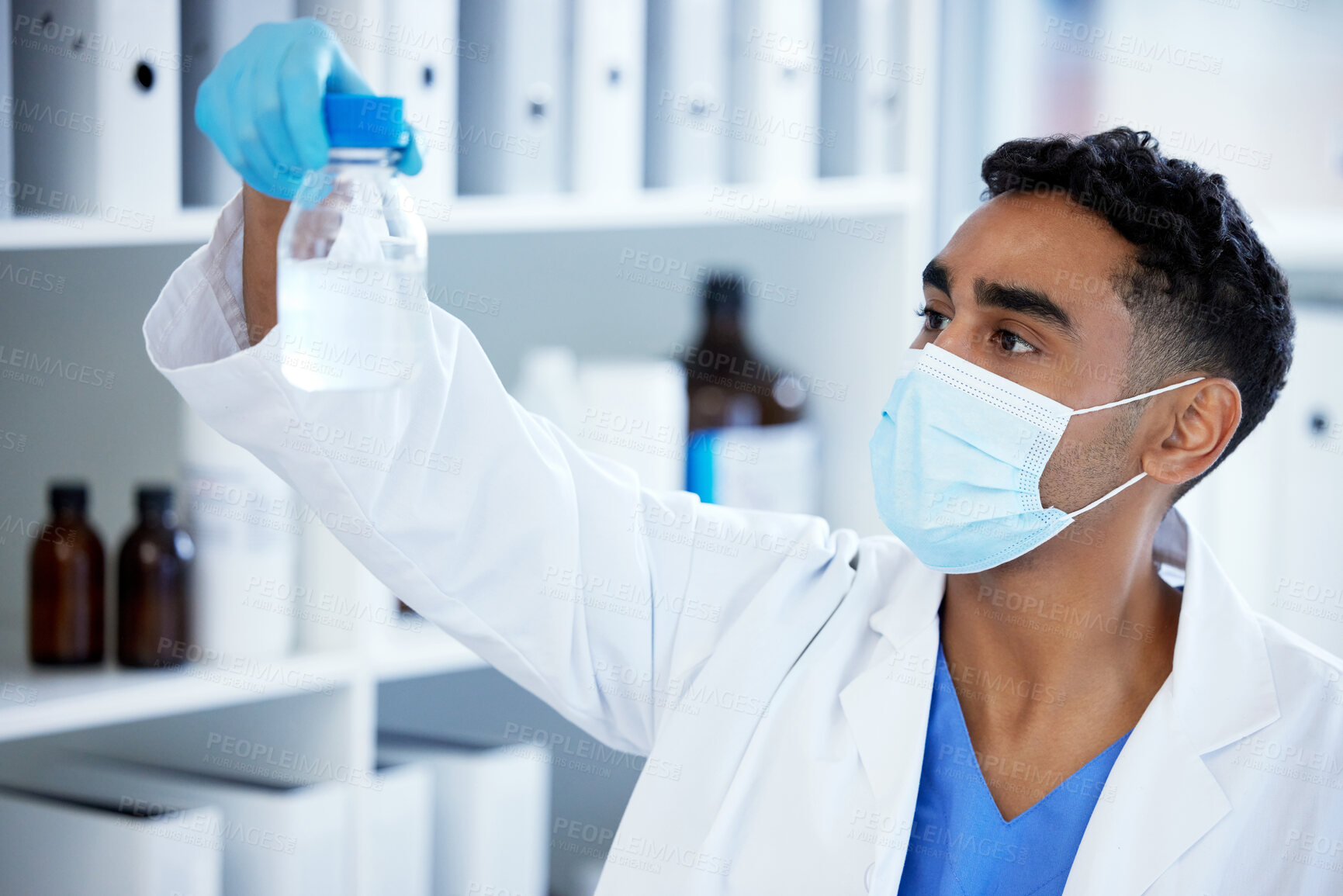 Buy stock photo Science, bottle and man with mask, liquid in container and medical research in laboratory. Vaccine innovation, scientist or lab technician with solution, glass or pharmaceutical development with ppe