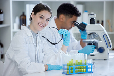 Buy stock photo Portrait of a young woman working in a lab with her colleague in the background