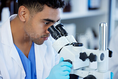 Buy stock photo Science, futuristic and a man with microscope in a lab for medical research and analysis. Serious, medicine and a scientist doing a check of chemistry, microbiology or a virus working at a clinic