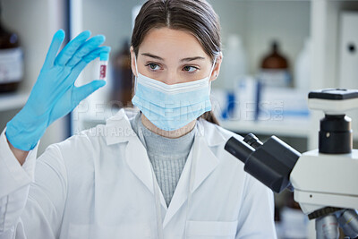 Buy stock photo Shot of a young woman analysing a sample in a lab