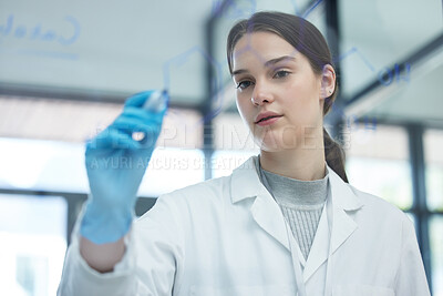 Buy stock photo Shot of a scientist solving equations on a glass screen in a laboratory