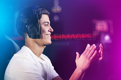 Buy stock photo Neon, man and clapping hands as gamer with playing on computer for online video games and happy. Headphones, esports and smile at home for victory on contest, challenge and competition on celebration