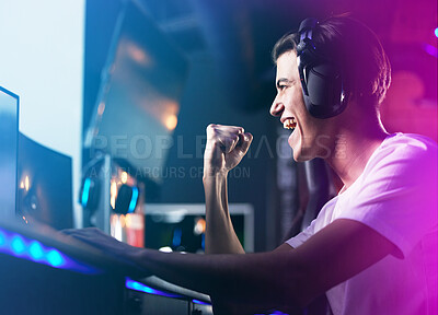 Buy stock photo Shot of a young man cheering while playing computer games