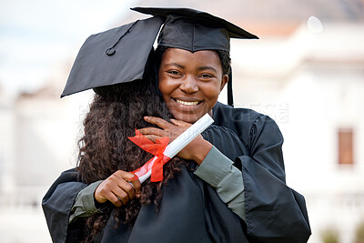 Buy stock photo Shot of two young women hugging each other on graduation day
