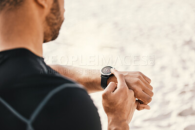 Buy stock photo Cropped shot of a man checking his watch while out for a workout