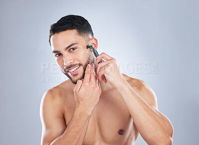 Buy stock photo Skincare, body and portrait of man shaving face in studio for wellness, hygiene and cosmetic treatment on grey background. Happy, beauty and Mexican model with facial, hair removal and razor blade