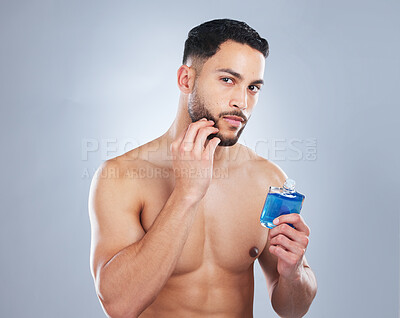 Buy stock photo Portrait, cosmetics and man with perfume bottle in studio for body care, fresh or grooming routine on grey background. Selfcare, cleaning and Mexican male model with cologne, application or scent