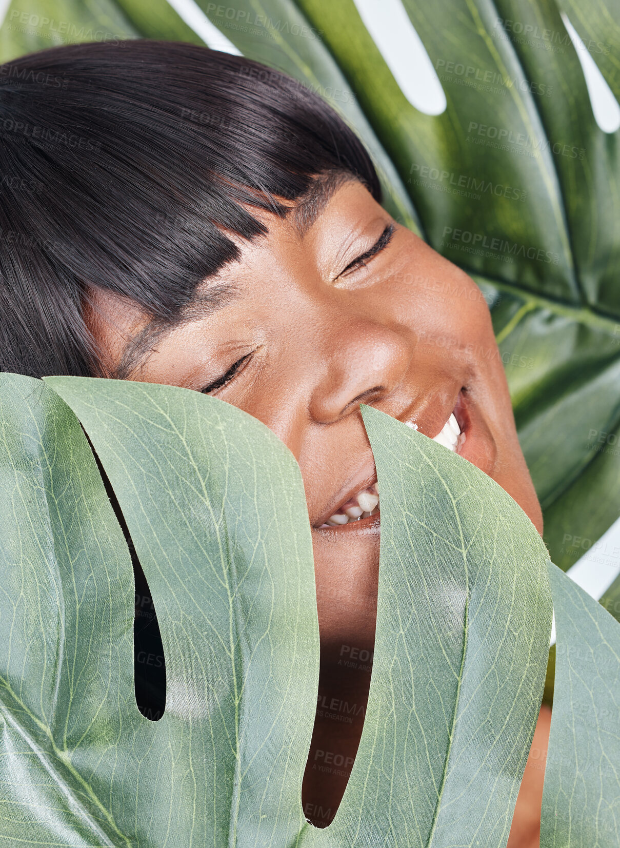 Buy stock photo African woman, skincare and leaves in studio with health, wellness or sustainable beauty by background. Girl, person and model by monstera plants, cosmetics and eco friendly makeup for transformation