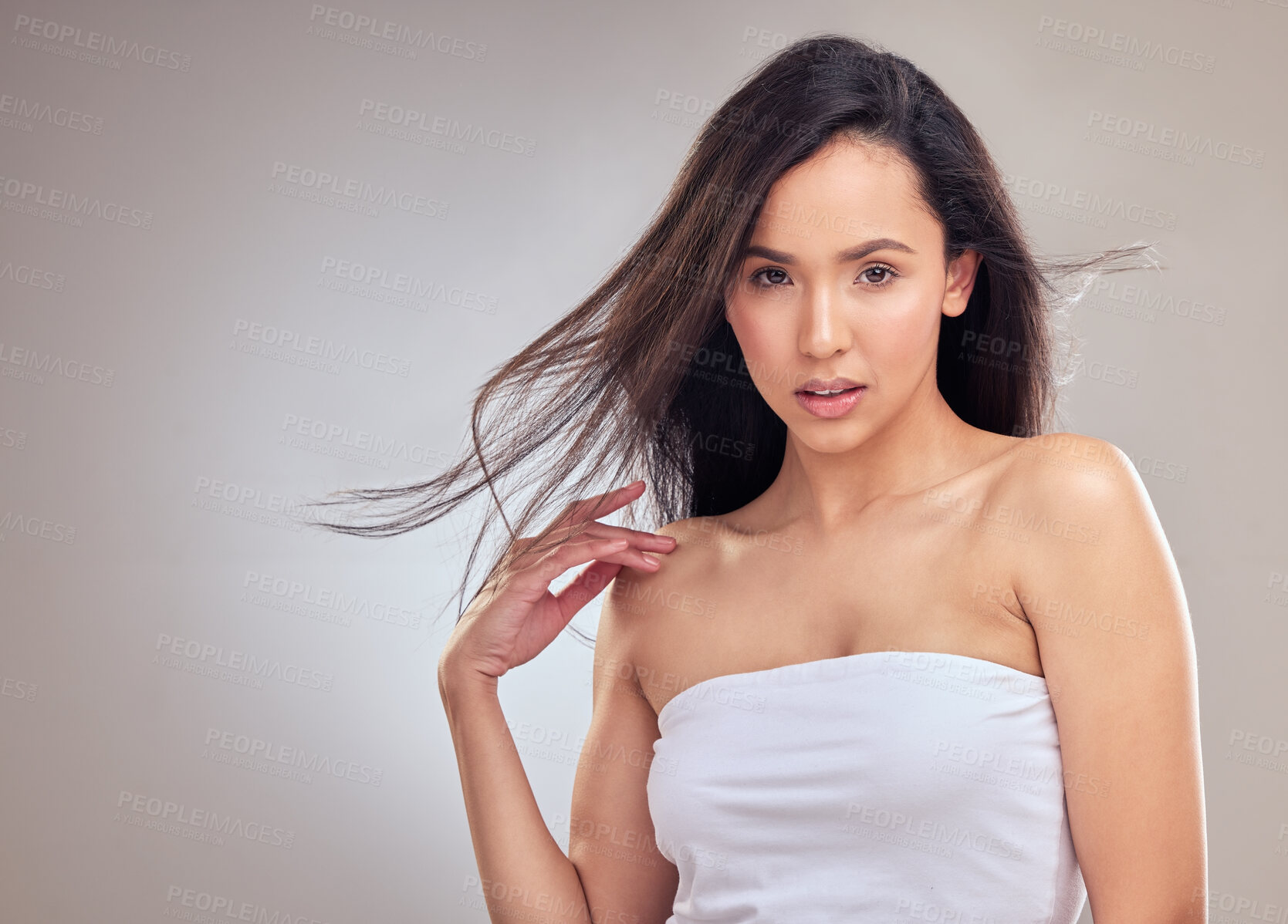 Buy stock photo Wind, portrait and haircare for woman in studio, healthy and promotion of hair, results and confidence. Brown background, salon treatment and growth for girl, hairstyle and proud of routine in USA