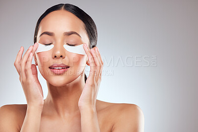 Buy stock photo Portrait, cosmetic and woman with eye patch, anti aging and skin glow for beauty on gray studio background. Skincare, facial detox and face of model with pads or collagen mask for dermatology product