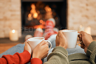 Buy stock photo Hands, coffee and couple relax by fireplace, bonding and cozy in home together. Tea, man and woman relaxing by fire on Christmas holiday in winter, heat and enjoying quality time with drinks in house