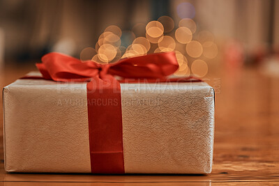 Buy stock photo Closeup shot of a gift box wrapped with a red bow during Christmas